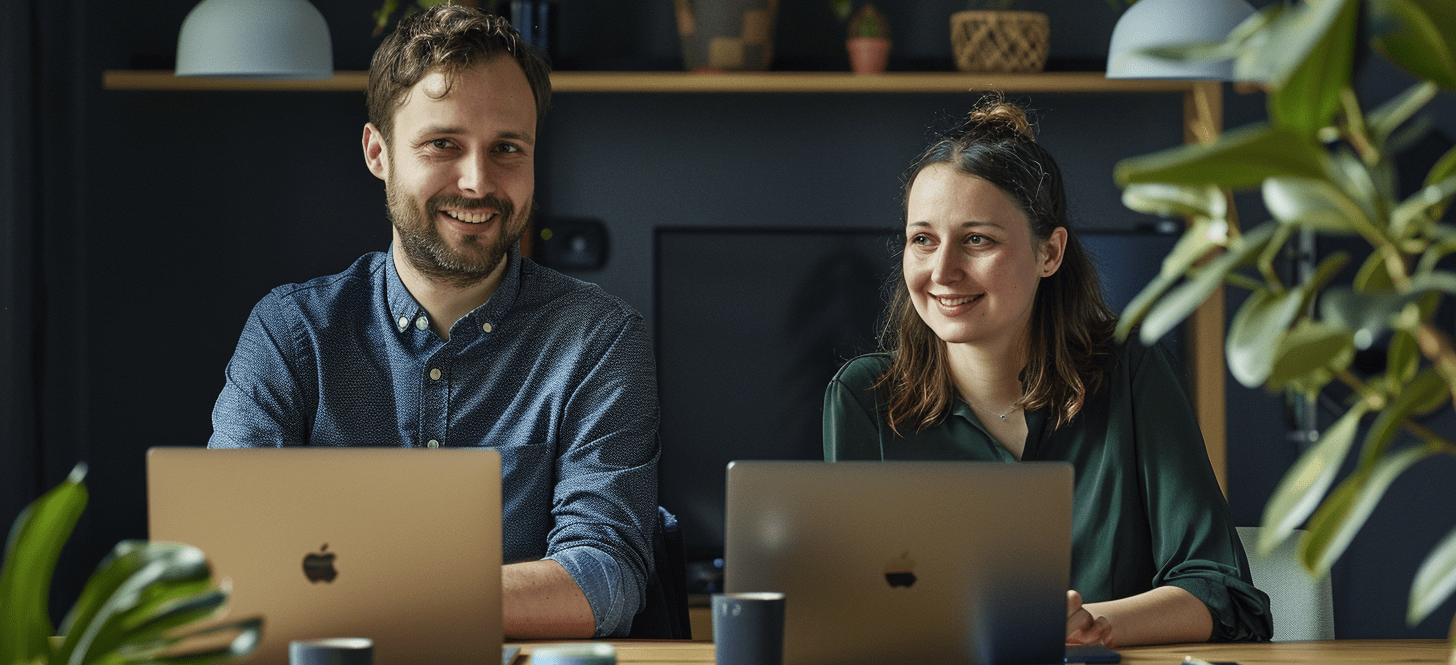 two professional people using their laptops